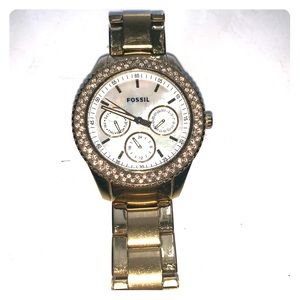 Gold fossil watch with crystal lined face.